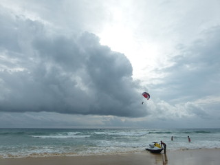 Big Clouds on Patong Beach at Phuket, Thailand with The sky is floating Parachute.