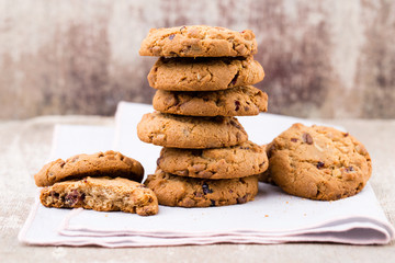 Chocolate oatmeal cookies on the wooden background.