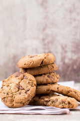Chocolate oatmeal cookies on the wooden background.