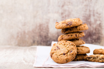 Chocolate oatmeal cookies on the wooden background.