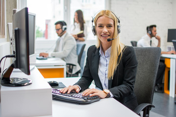 Portrait of pretty young blonde woman dispatcher working in call center