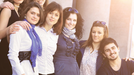 cheerful group of students smiling and looking into the frame.