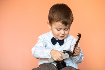 Little boy with aged retro camera. Child with an old camera