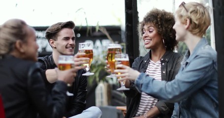 Friends drinking in an outdoor bar in summer