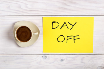 Coffee cup and text  day off on wooden table.