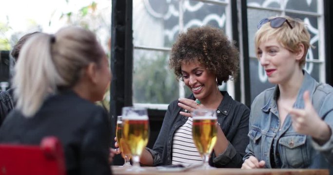 Friends drinking in an outdoor bar in summer