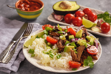 Pulled lamb with boiled rice and vegetables.