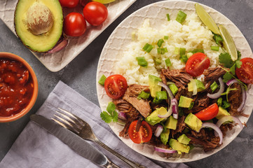 Pulled lamb with boiled rice and vegetables.