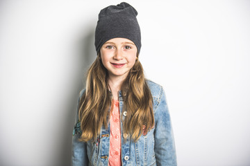 Portrait of a little girl. Studio photography of girl have toque on head