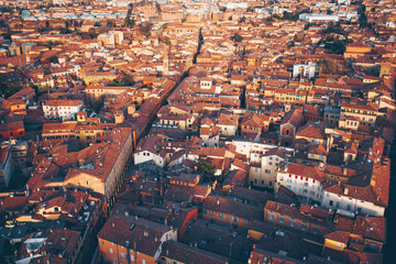 Aerial view on roofs of old city Bologna, Italy in sunset.