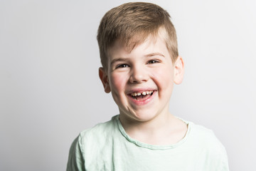 five year old boy posing over white studio background