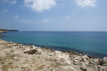 Rocks and sea on the coast under a blue sky. Landscape.