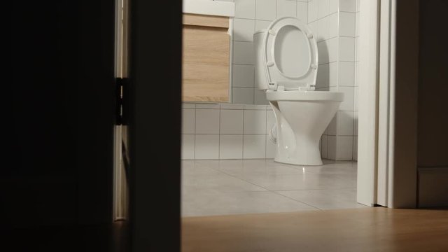 Door of bathroom is closing slowly in the night