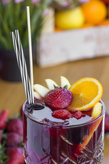Cocktail with vodka, strawberries and lemon in glass