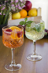 Two cocktails with vodka, strawberries, mint and lemon in glasses
