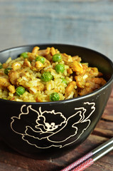 Fried rice with chicken in Chinese in a black bowl