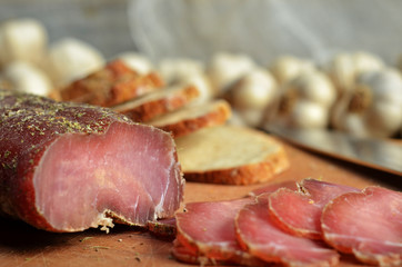 Dried sirloin with herbs on a wooden board