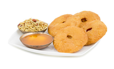 Indian Traditional Sweet Kachori Also Know As Mawa Kachori, Kachauri or Kachodi, Stuffed Kachori With Condensed Milk, Cheese and Dry Fruits And Served With Sugar Syrup isolated on White Background