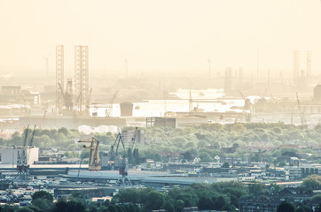 Aerial view across the city of Rotterdam, The Netherlands towards the harbour and industrial areas...