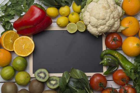 Various fruits and vegetables with vitamin c, blackboard