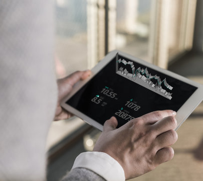 Woman using tablet with data emerging from screen