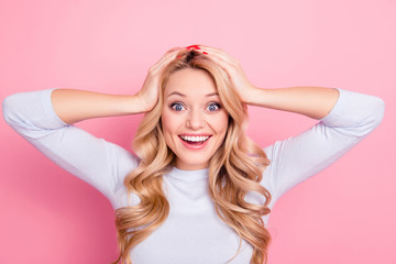 OMG! Portrait of shocked wondered girl with modern hairdo beaming smile holding hands on head looking at camera isolated on pink background