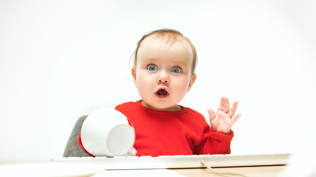 Happy Child Baby Girl Toddler Sitting With Keyboard Of Computer Isolated On A White Background