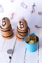 Egg with bitcoin in a wooden small barrel