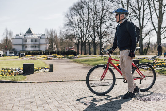 Senior man with bike in a park