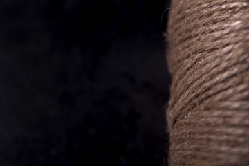 Natural thread in the coil on a black background