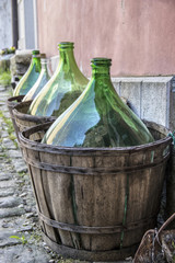 Istria, Croatia -  Large empty of wine in wooden carriers placed next to the wall 