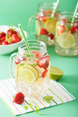 refreshing summer lemonade with strawberry and lime in mason jar