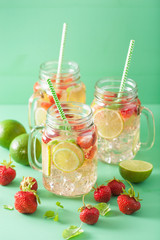 refreshing summer lemonade with strawberry and lime in mason jar