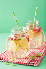 refreshing summer lemonade with strawberry and lime in mason jar