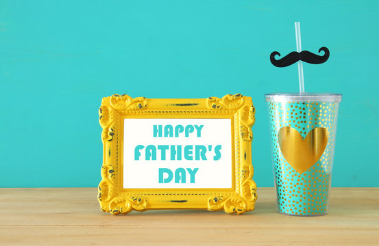 Image of plastic cup with golden heart. Father's day concept.