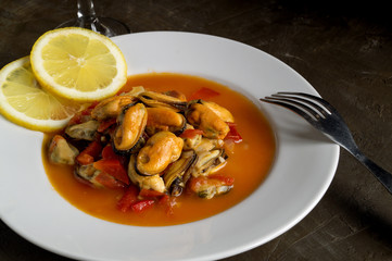 mussels in tomato sauce on a white plate