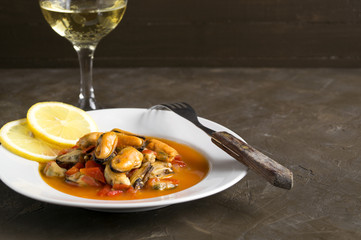 mussels in tomato sauce on a white plate