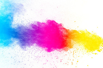 Multi color powder explosion on white background. Launched colorful dust particles splashing.