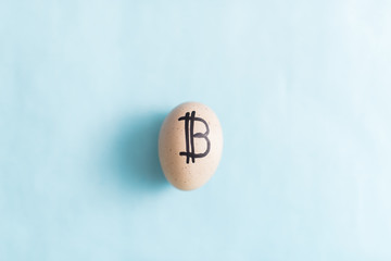 Egg with bitcoin on a blue background