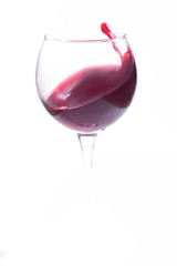 A glass with red wine on a white background. Isolate