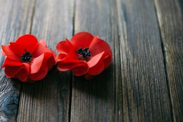 Red poppies on a wooden dark background