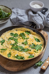 Omelette with baby kale leaves