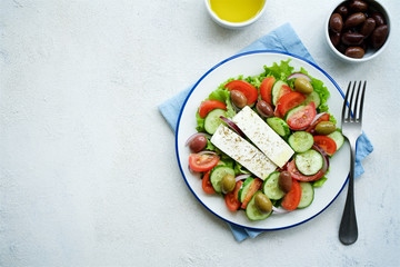 Traditional Greek salad. Light and healthy food. White food background