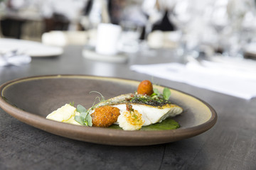 Plate with tasty fish steak on grey background