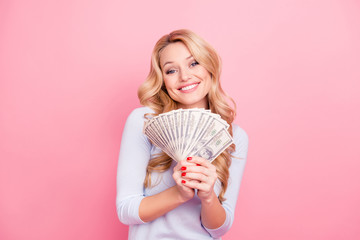 Portrait of cute positive girl in casual outfit holding fan of a lot of, much money for shopping in...