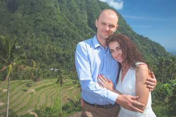 Happy couple walking at the rice terraces. Traveling at Bali.