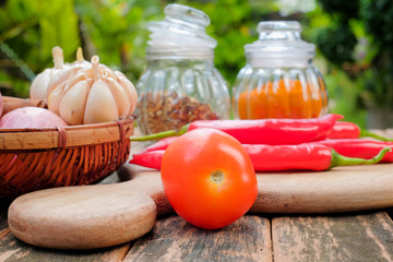 Curry powder, chili powder,herbs,  tomato, cinnamon, garlic, onion, chili, on an old table. Concept cuisine Asian countries