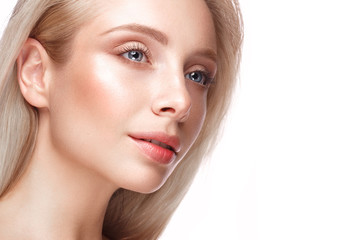 Fototapeta premium Beautiful young girl with a light natural make-up and perfect skin. Beauty face. Picture taken in the studio on a white background.