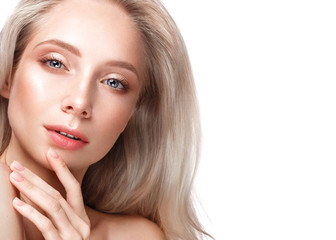 Fototapeta premium Beautiful young girl with a light natural make-up and perfect skin. Beauty face. Picture taken in the studio on a white background.