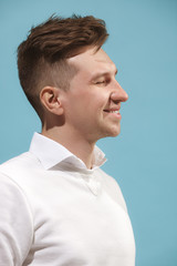 Fototapeta premium The happy business man standing and smiling against studio background.